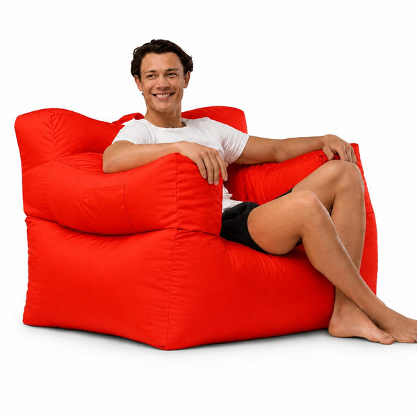 smiling man posing on a red armchair bean bag