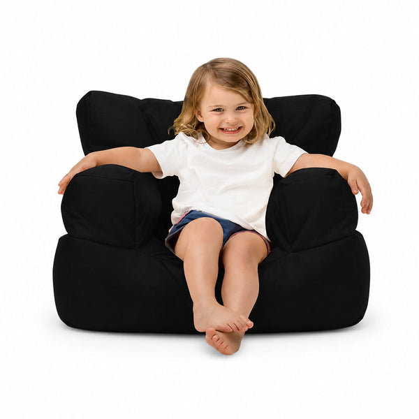 smiling young girl posing on a black kids bean bag chair