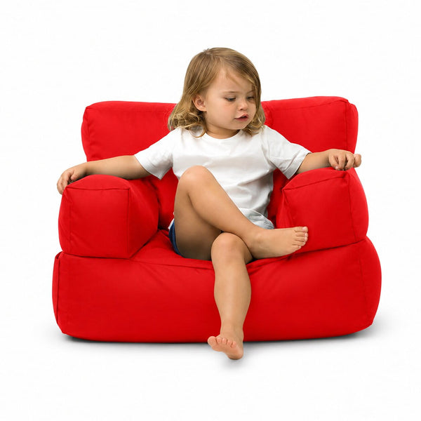 smiling young girl posing on a bright red kids bean bag chair