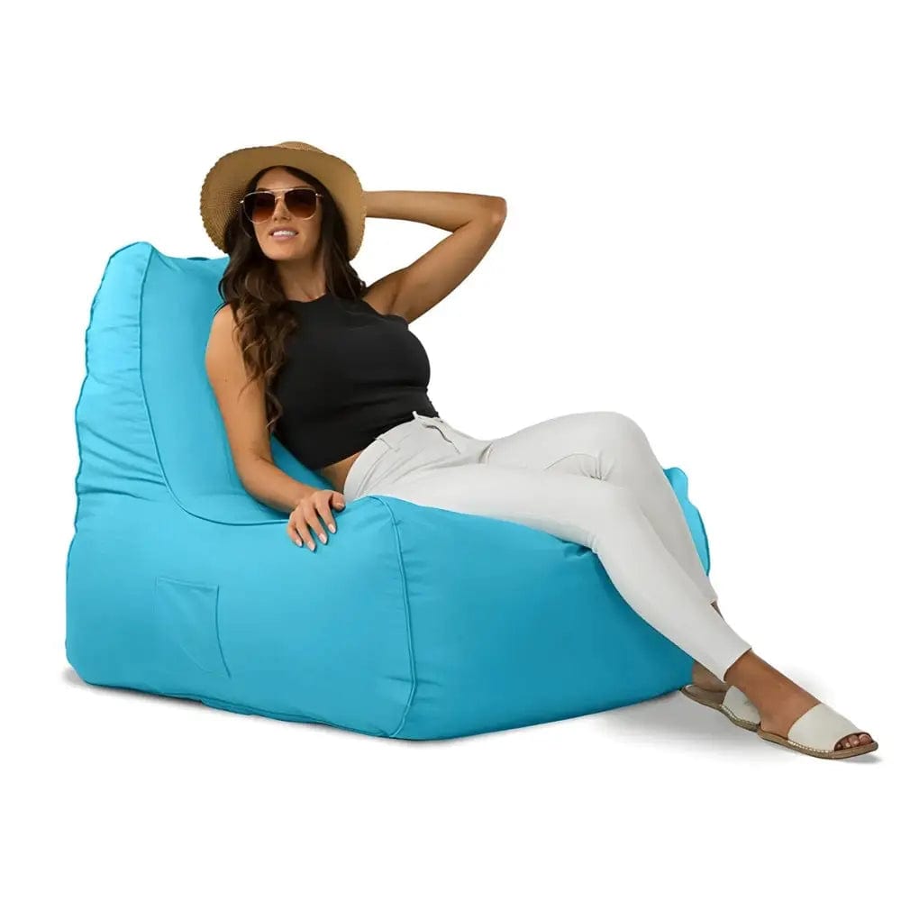 Woman sitting on a blue bean bag chair against a white background
