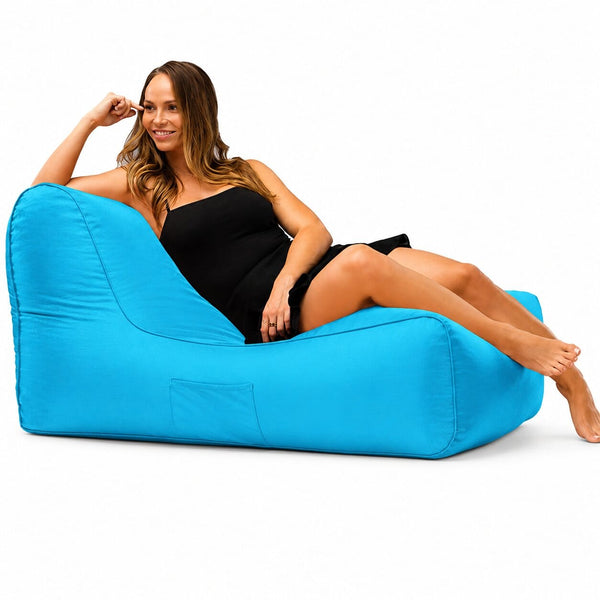 lady posing on a media lounge outdoor bean bag lounger in aqua