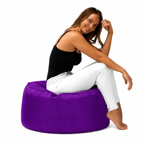 lady posing on a purple outdoor bean bag ottoman by bean bags r us