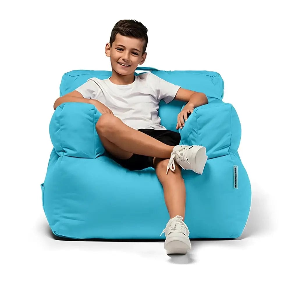 Child sitting on a large blue bean bag chair against a white background