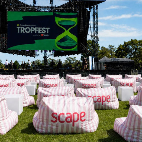Rows of pink and white striped scape-branded bean bags on the lawn facing the Tropfest 2026 stage in Centennial Park, Sydney