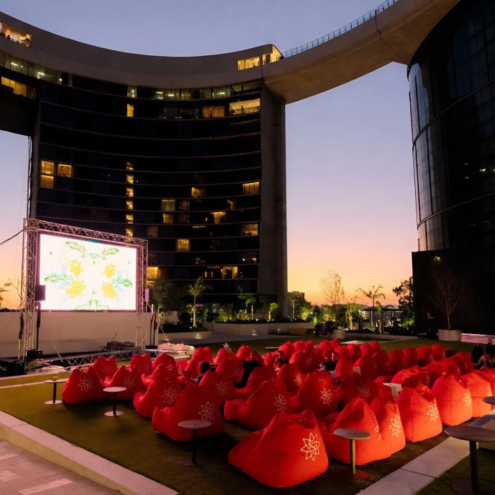 Red bean bags printed with The Star logo set up for Skyline Cinema at dusk on the Queen's Wharf Leisure Deck