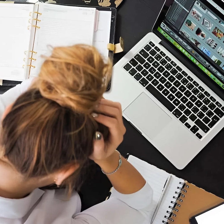 stressed lady sitting at her laptop working