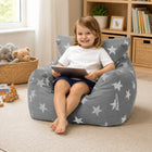smiling young girl sitting on a grey bean bag chair with silver stars holding an I-pad — thumbnail 7