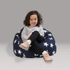 Child sitting on a navy bean bag with white star pattern