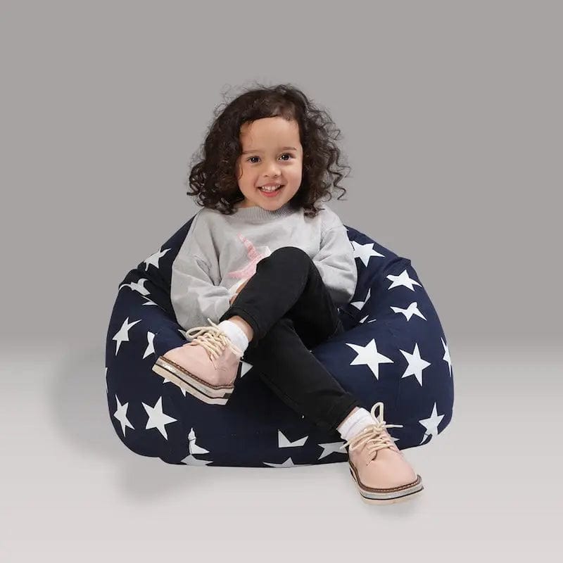 Child sitting on a navy bean bag with white star pattern