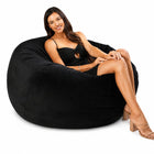 happy lady posing on a black velvet bean bag chair — thumbnail 3