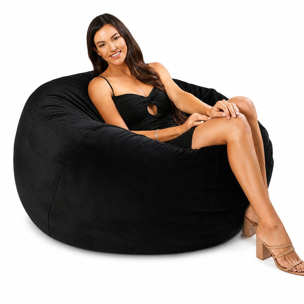 happy lady posing on a black velvet bean bag chair — image 3