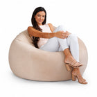 smiling lady posing on a cream velvet bean bag chair — thumbnail 8