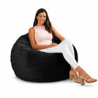 smiling lady posing on a black velvet bean bag chair — thumbnail 9