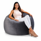 smiling lady posing on a grey velvet bean bag chair — thumbnail 10