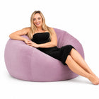 happy lady posing on a pink velvet bean bag chair — thumbnail 2