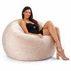 happy lady posing on a beige velvet bean bag chair — thumbnail 4