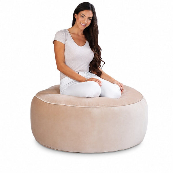 lady posing on a beige velvet bean bag ottoman by bean bags r us — image 3