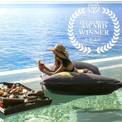 Woman relaxing on a inflatable lounger by a pool with a 'Evergreen Award Winner 2025' logo.