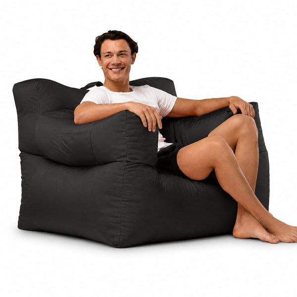 smiling man posing on a grey armchair bean bag — image 7