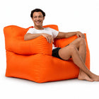 smiling man posing on an orange armchair bean bag — thumbnail 9