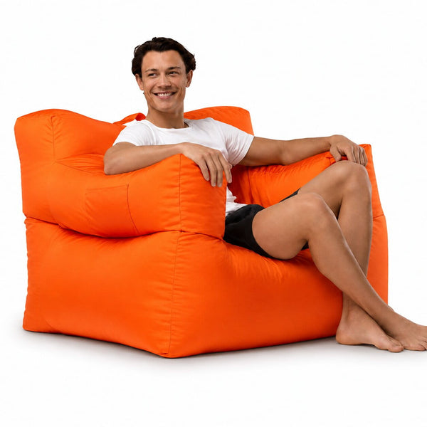smiling man posing on an orange armchair bean bag — image 9