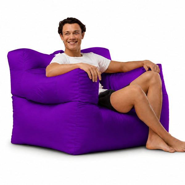 smiling man posing on a purple armchair bean bag — image 10