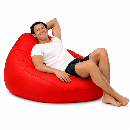 smiling man posing on a red adult bean bag chair