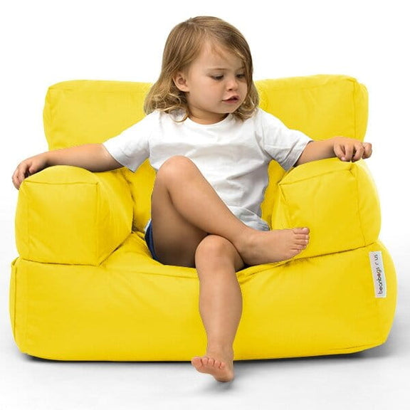 young girl sitting on a yellow kids beanbag chair