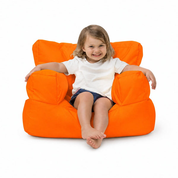 smiling young girl posing on an orange kids bean bag chair — image 13