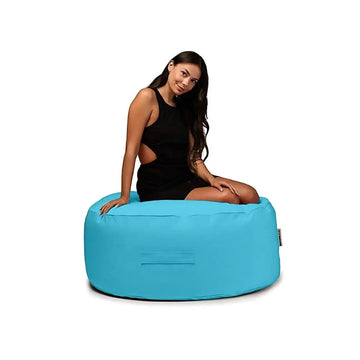 Woman sitting on a blue bean bag chair against a white background