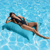 Woman lounging on a blue pool pillow in a pool