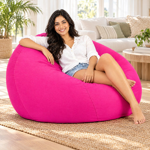 Pink Coco 112cm cotton bean bag with woman relaxing in a bright living room, Bean Bags R Us
