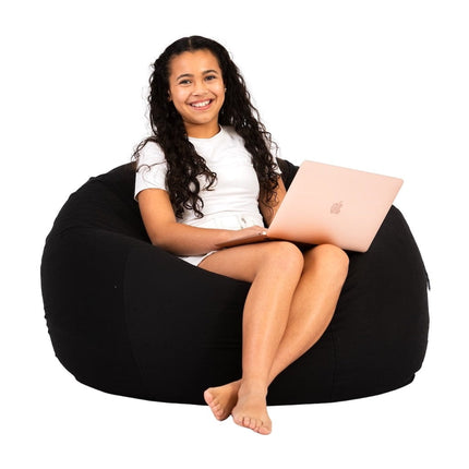 teenage girl sitting on a black cotton beanbag chair