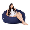 teenage girl sitting on a navy cotton beanbag chair