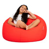 teenage girl sitting on a bright red beanbag chair