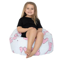 Child sitting on a bean bag with pink love pattern