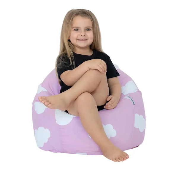 Child sitting on a pink bean bag with white cloud patterns