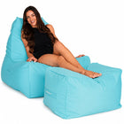smiling lady posing on a capri blue Copacabana outdoor bean bag chair and ottoman — thumbnail 2