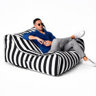 man posing on a black striped costa outdoor bean bag lounger by bean bags r us — thumbnail 12