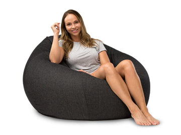 lady sitting on a charcoal denim bean bag