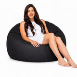 happy lady posing on a charcoal denim bean bag