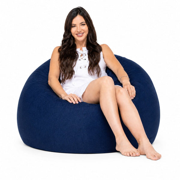 lady posing on a blue denim bean bag chair — image 2