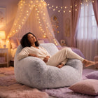 a lady relaxing on a foam filled sensory bean bag chair in a pink bedroom — thumbnail 2