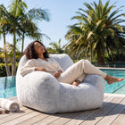 a lady relaxing on a foam filled sensory bean bag chair on a deck — thumbnail 3