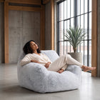 a lady relaxing on a light grey coloured foam filled sensory bean bag chair  — thumbnail 4