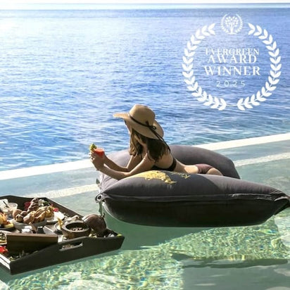 Woman relaxing on a inflatable pool float by the pool with a 'Evergreen Award Winner 2025' badge.