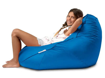 Person sitting in a blue bean bag chair on a white background