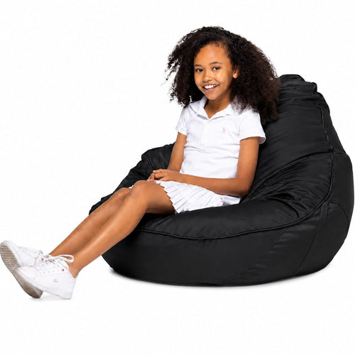 smiling teen girl sitting on a freaky cousin black bean bag chair