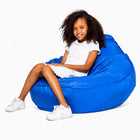 smiling teen girl sitting on a freaky cousin blue bean bag chair — thumbnail 13