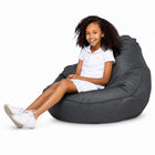 smiling teen girl sitting on a freaky cousin charcoal bean bag chair — thumbnail 14